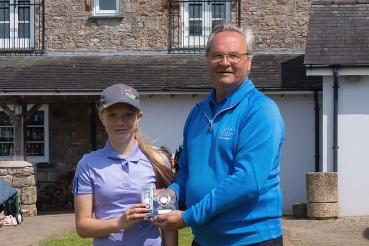 Lacey Rees being presented with his trophy and prize by Trefloyne club captain Eifion Price