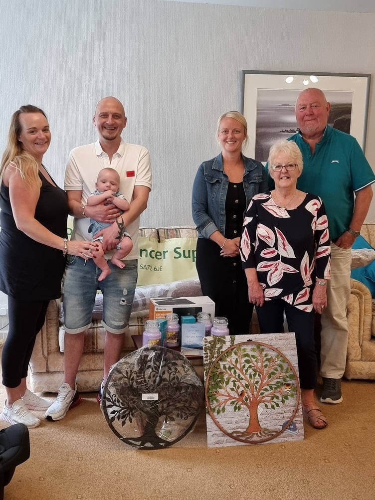 Pembrokeshire Cancer Support Volunteer Sandra receives the gifts from the family of the late Wendy Jane Griffiths.