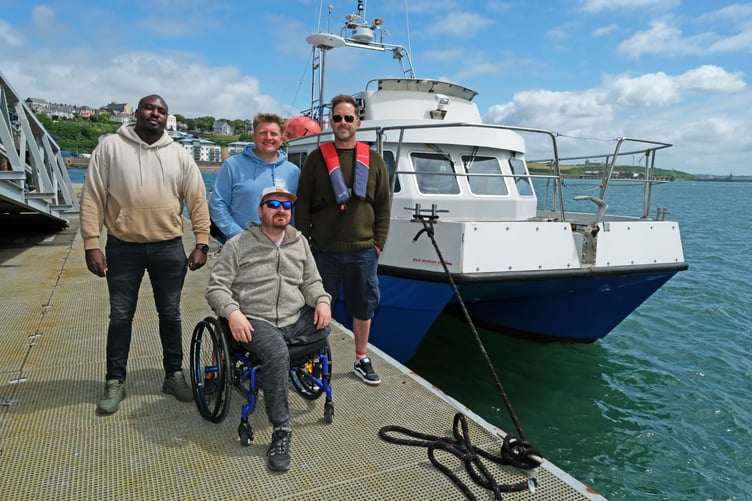 Members of the VC Gallery prepare to enjoy a boat trip with Oliver Bird from Blue Horizons Surf School (centre) and Coxswain at the Port of Milford Haven Graham Howells (right).