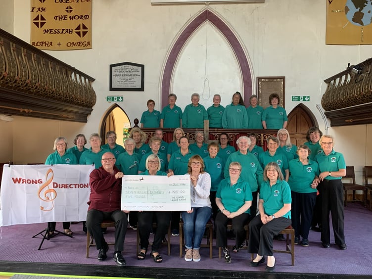 Neyland Ladies Choir with Neil martin from Wrong Direction, presenting a cheque to Tracey of Roko 20 Academy charity