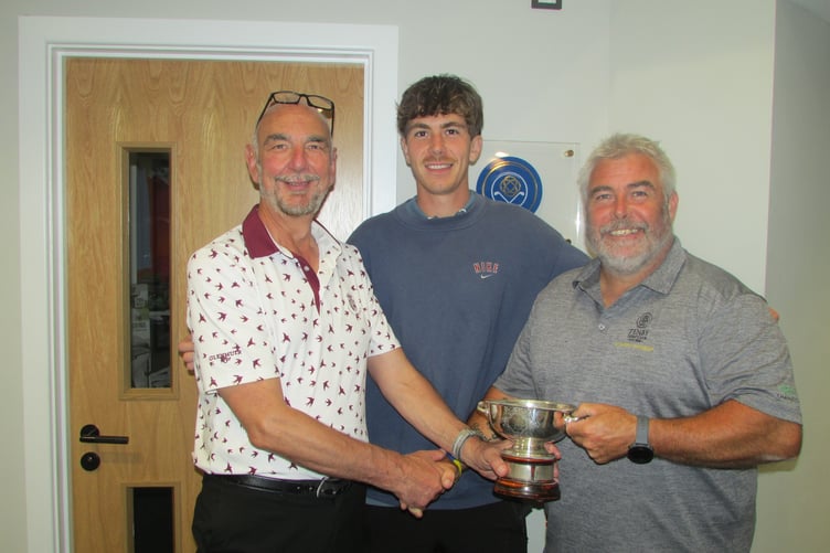 Dave Hancock (Tenby GC Manager) presents the R A Cup to Jamie and Dean Rossiter.