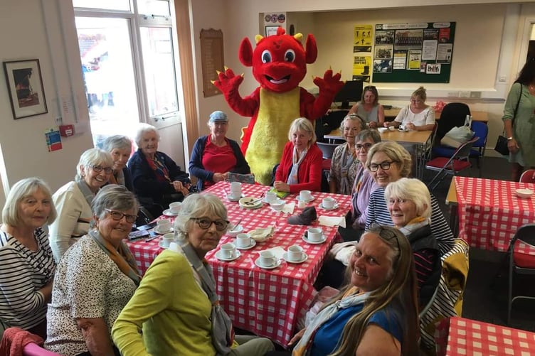Members of Lower Landsker Trefoil Guild at Tenby Fire Station, and a cuddly dragon with personal experience as a Brownie and Guide!