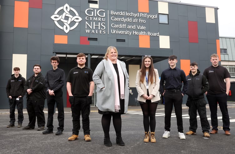 Emma Bendle (centre), apprenticeship and widening access co-ordinator, with staff and apprentices at Cardiff and Vale University Health Board.