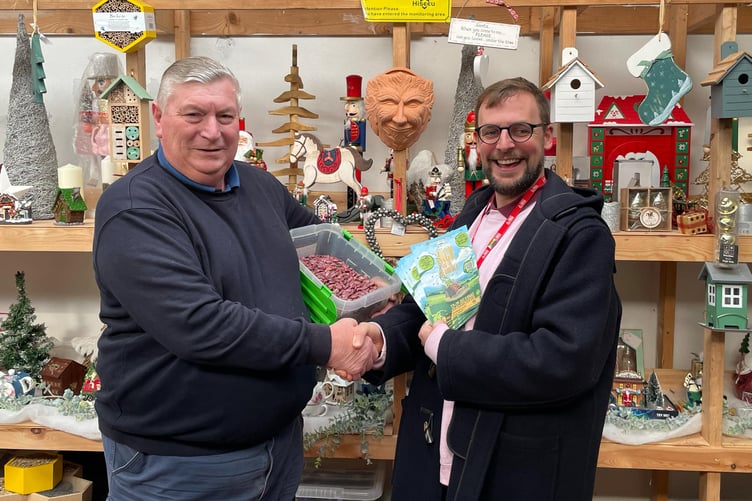 David Charles from Elder Meadows Nursery giving a large bag of beans to Tim Howe, from the Torch Theatre for the 'Magical Beans' competition - part of this year's Torch Christmas pantomime of Jack and the Beanstalk.