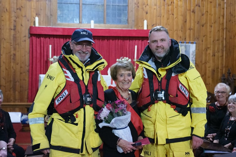 Representatives from the Angle Lifeboat RNLI crew, in full uniform, presented long-standing Neyland Ladies Choir member Dorothy Beckett with a long service medal and flowers.