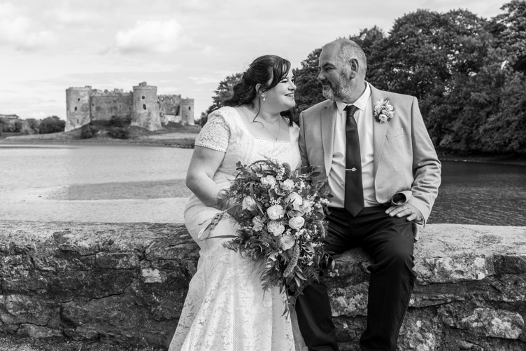Wedding couple at Carew with castle in background