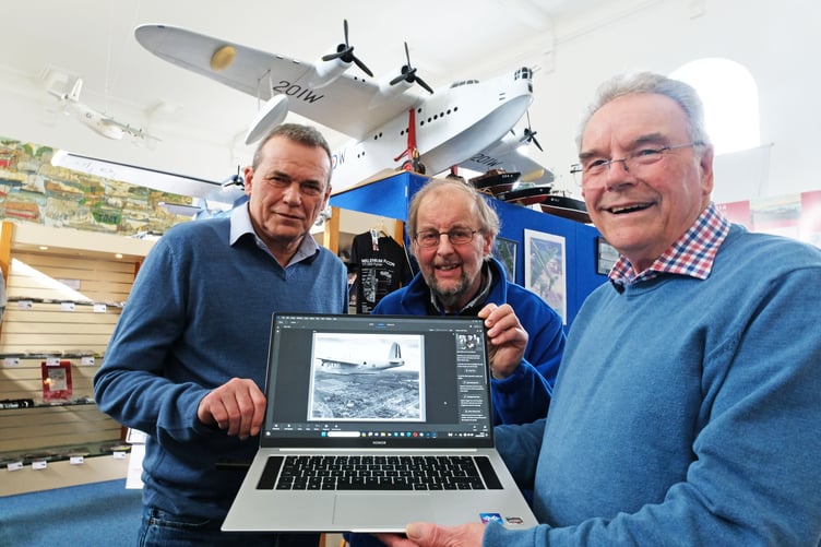 Ken Edwards shows Chris Osborne (left) and John Evans another of the Sunderland photographs added to the digital archive at Pembroke Dock Heritage Centre. Photo: Martin Cavaney Photography