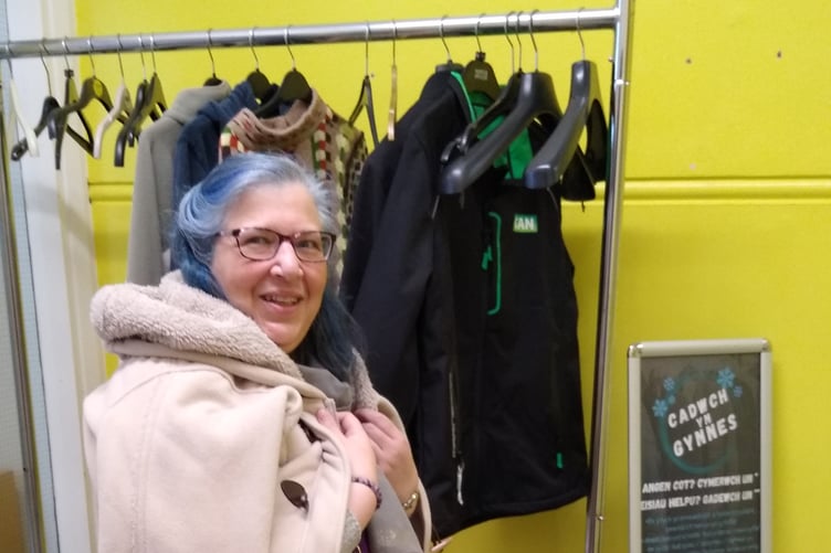 Tenby Library warm coat rail donation being modelled