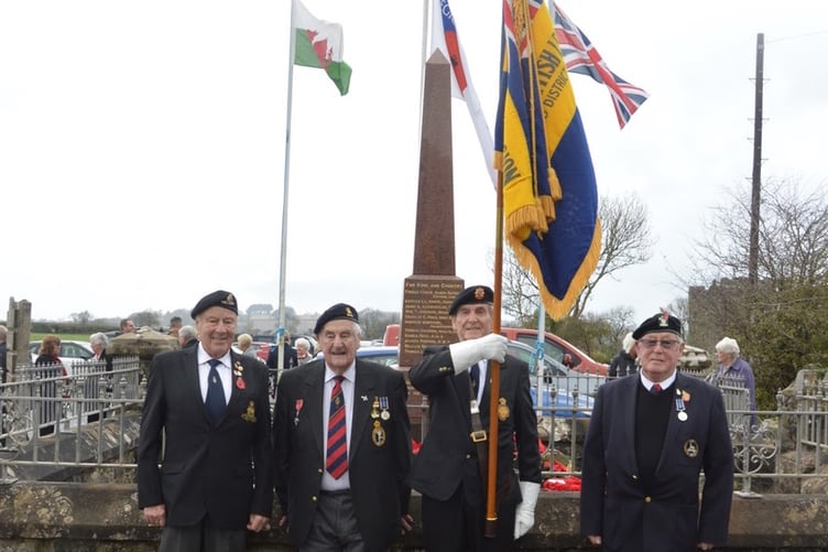 Pictured at the Carew War Memorial on Remembrance Sunday are members of the Cresselly and District British Legion, Standard Bearer Gerald Williams and Escorts Denzil Griffiths and Graham Roberts. With them is 97 year old Royal Signals Veteran John Brock MBE who during his service was attached to The Sudanese Defence Force.