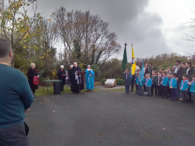 A large group of local residents gathered in Kilgetty Community Garden for a service of Remembrance last Sunday. Then Scout representatives lowered their standards for the two-minute silence. After the singing of both national anthems, representatives of local groups laid wreaths and crosses around the memorial plaque which honours men of Kilgetty and Begelly.