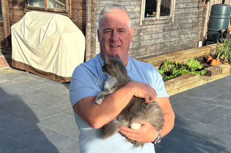 Alan Vickery with family cat Bella. Release date November 14 2024. A family cat used up all nine lives after she snuck into a delivery van - and ended up in a lorry depot 240 miles and SIX HOURS from home. Alan Vickery, 58, noticed one of his cats, Bella, was missing after she didn't come home for her dinner on Monday (8). Bella would rarely leave their house, in Tenby, Pembrokeshire, so Alan and wife Katrina Vickery, 52, grew concerned. They had a new bed frame delivered by a logistics company, D4U, that evening - and feared Bella might have snuck into the van to explore.