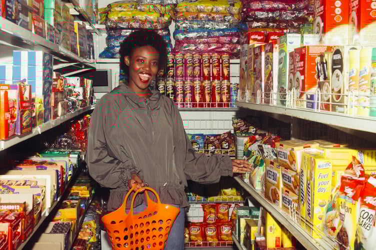 Shopper in convenience store surrounded by temptations and unhealthy food options