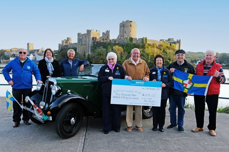 Mal Powell presenting a donation of £2,335 to Sandra Dade, Charity Manager at Paul Sartori, along with volunteers Val Harrold and Mair Evans, and Trustee Phil Thompson.