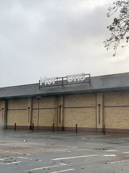 The damaged 'Morrisons' sign at Morrisons' supermarket in Aberystwyth, Ceredigion, Wales.  Photo released December 10 2024. Supermarket bosses are rushing to fix an offensive sign exposed as part of Storm Darraghs destruction.Joshua Jones, 26, snapped pictures of the offensive message as he visited the supermarkets location in Aberystwyth, Ceredigion, Wales.His first thought while seeing the sign was that it was the English word morons  referring to stupid people.However, in Wales, the word moron can also have a different meaning  translating into English as carrot.

