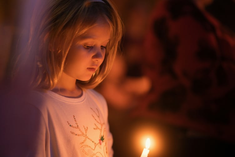 Child at Candlelight Christmas carol service