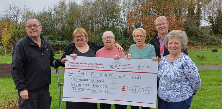 Pictured are residents at St Davids Avenue in Whitland - John, Bobbie, Jocelyn, Wendy, Ann presenting the donation to Regional Fundraising Manager for the Wales Air Ambulance Mike May.