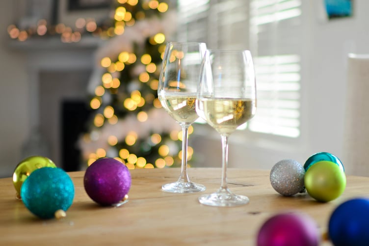 Wine glasses and Christmas baubles - party stock image