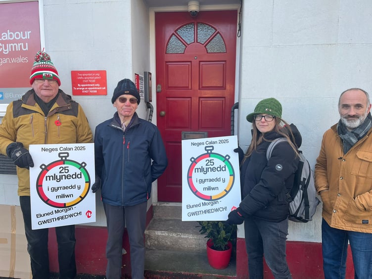 Cymdeithas members leaving the card at Eluned Morgan's office in Haverfordwest