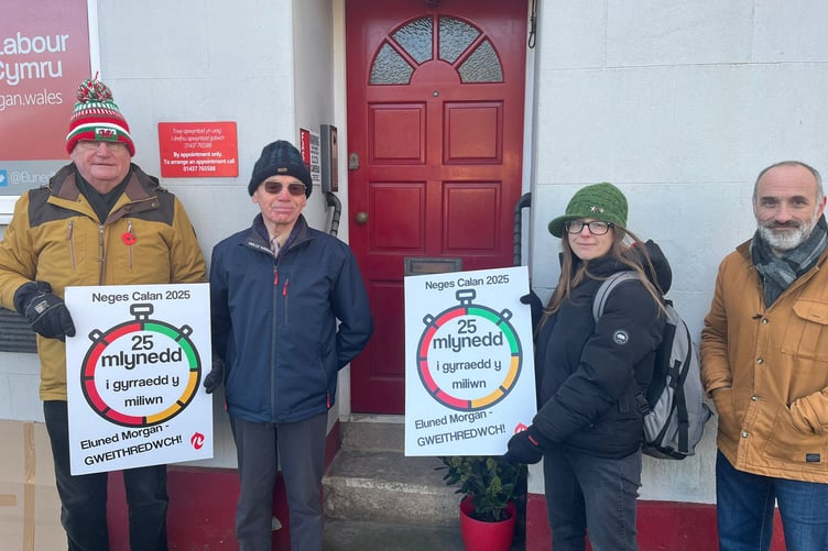 Cymdeithas members leaving the card at Eluned Morgan's office in Haverfordwest