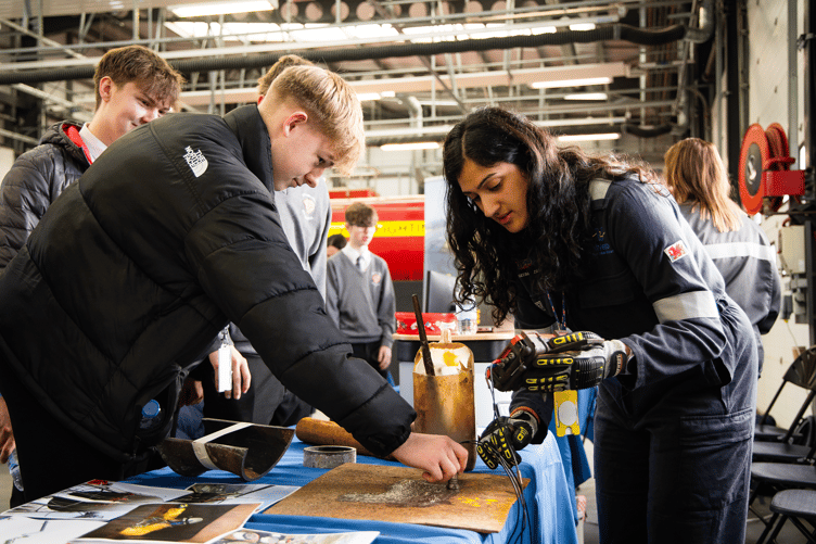 Valero Pembroke Refinery Corrosion Engineer Adeeba Zachary demonstrates how corrosion is measured using ultrasonic equipment.
