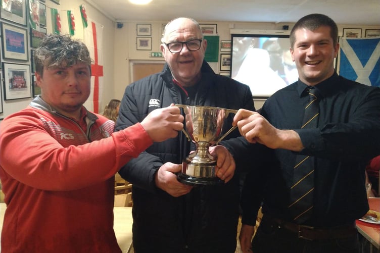 Pembroke President Dilwyn Williams and Llangwm skipper Ryan Banner present Pembroke captain Lloyd Davies with the Palmer Cup