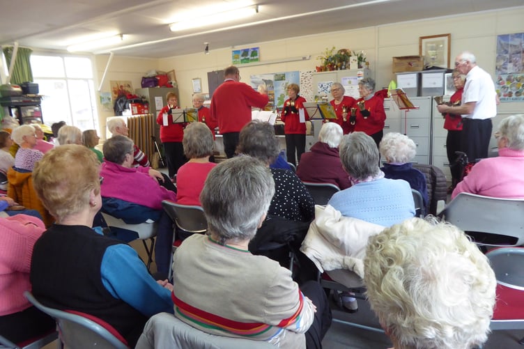 Tenby Friendship Club enjoying a performance of St Mary's Bell Ringers at Augustus Place Community Hall