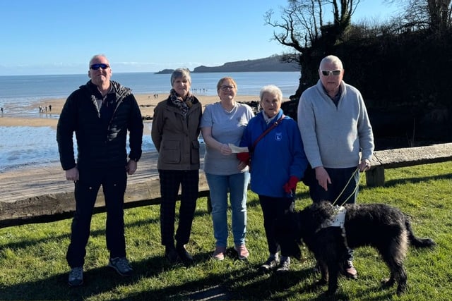 Tenfoot Swim representatives donating the £1,125 raised to local Guide Dogs Cymru branch members. Pictured, from left to right: Anthony Mattick, Kim Denning, Lynn Knibbs, Eva Rich, Adge John and guide dog Skip