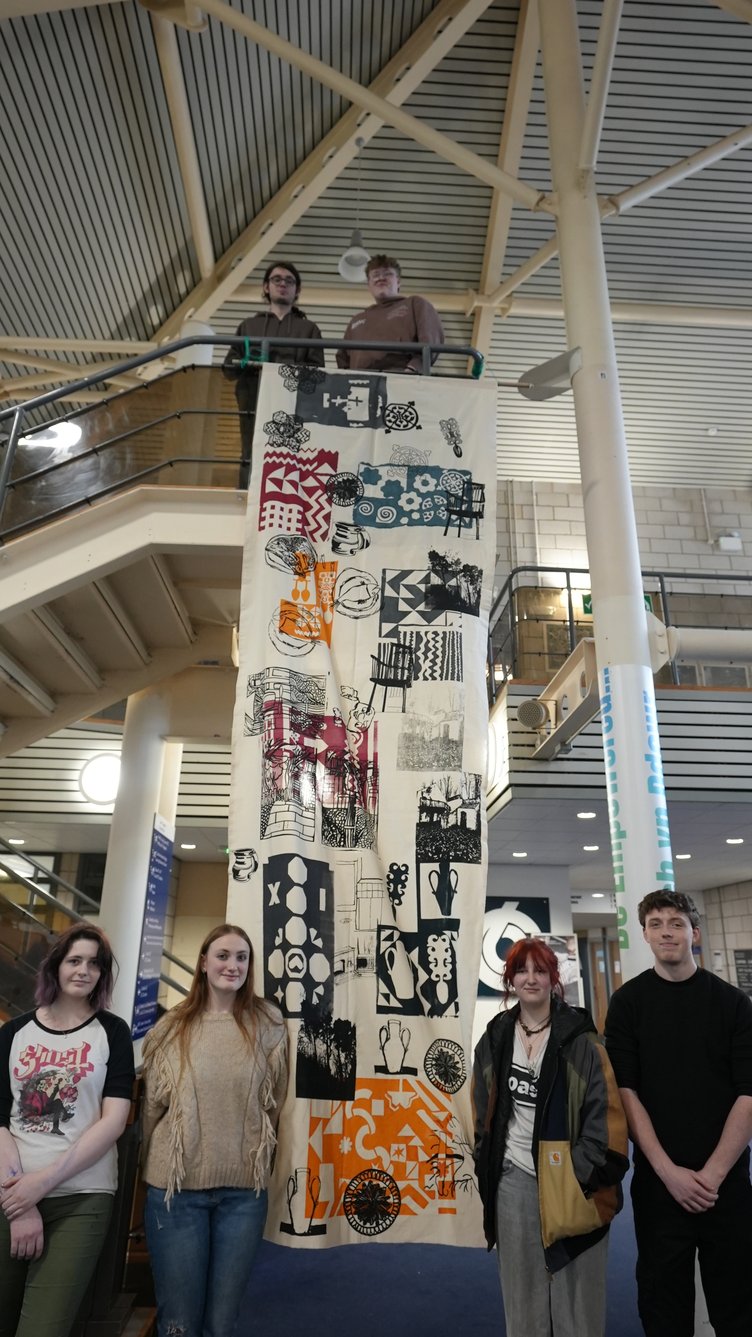 Pembrokeshire College Art and Design learners with the banner