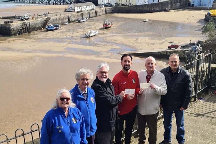 Pictured at the cheque presentation are (from left); Julie Buckland (Lions Vice President), Andrew Mayes (Lions Treasurer), Roly Fury (Lions President), Adam Hughes, Tom Cullen (Tenby Rotary President) and Nick Stapleton (Lions) 