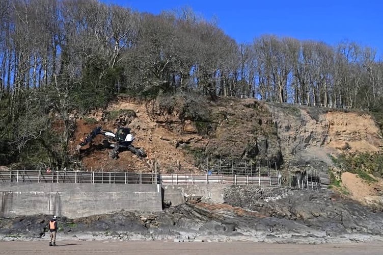 A specialist ‘Spider Excavator’ arrived onsite on March 31 - to ‘climb up’ from the beach onto the path to clear the fallen rock (Photo by Gareth Davies Photography)