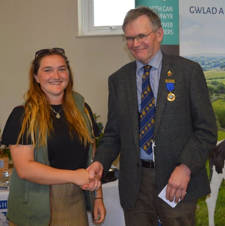 2023 Pembrokeshire County Show bursary winner Lottie Wilson receiving her £1,000 prize from Robert James
