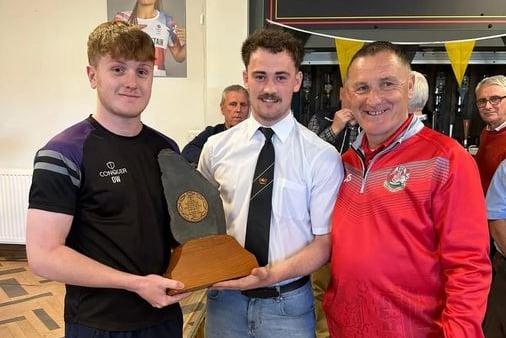 Oscar Willington presents the Slate trophy to St Davids skipper.