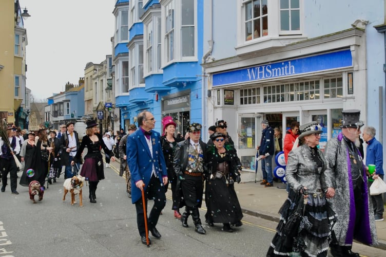 Steampunk Festival parade past WHSmith in Tenby, which has been located at 7 High Street since 1927. The photo by Malcolm Richards marks a moment in history as the brand name is set to disappear from the town following the sale of the high street stationery stores to Modella Capital who intend to rebrand it as TGJones.