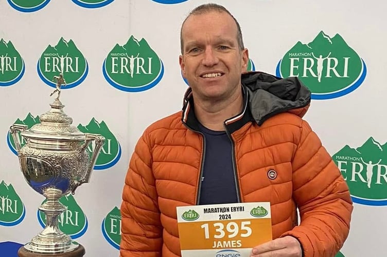 Jim Cornock pictured when he collected his number for Marathon Eryri which he also ran to raise funds for Tenovus Cancer Care