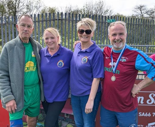 Haverfordwest County Walking Football Chairperson Paul Williams, with Dean Flood event organiser and staff from SNAP