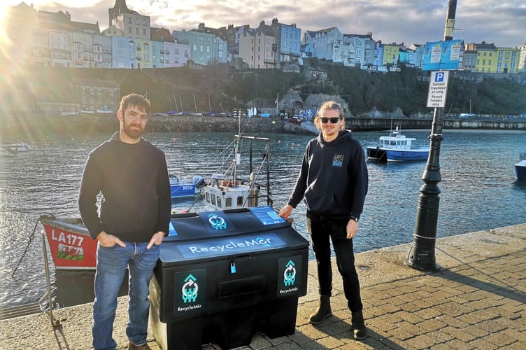 Project Officer, Lloyd Nelmes, pictured with Tenby Harbourmaster Chris Salisbury with a 'Recycle Mor' bin at the seaside town.