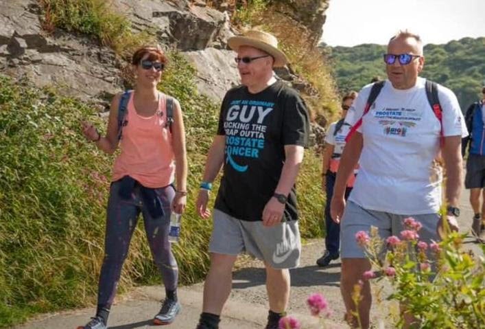 Cllr Guy Woodham (pictured centre) with cousin Gemma and his husband Colin on a charity walk for prostate cancer last year.