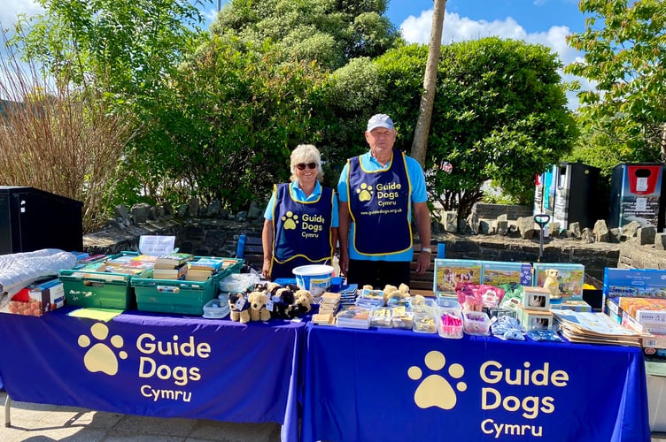 Pic: Volunteers Helen and Tony Hedley at the Guide Dogs stall in Saundersfoot Harbour
