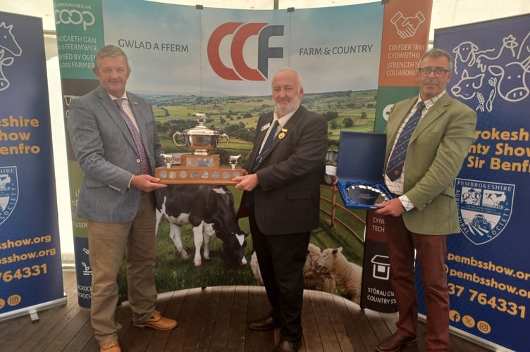 Picture caption: Last year’s winner Michael Davies receiving his award from former NFU Cymru Pembrokeshire County Chairman Simon Davies. Also pictured is Jeff Evans from the award’s management committee. 