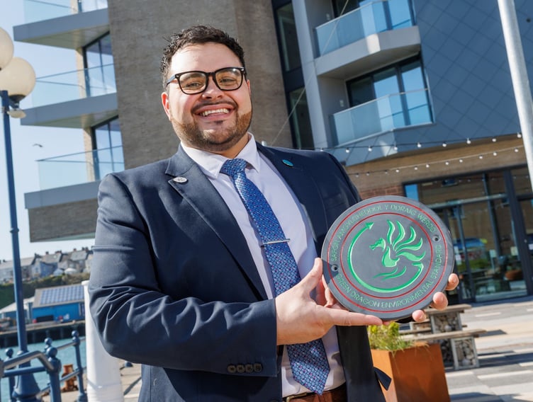 Tŷ Hotel Milford Waterfront Manager Mathew Verallo is pictured with the Green Dragon Level 4 Environmental Standard