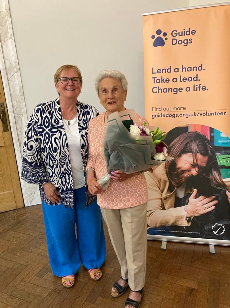 Pembrokeshire volunteer Lynn Knibbs with Lifetime of Service award winner Eva Rich, who is holding a bouquet.