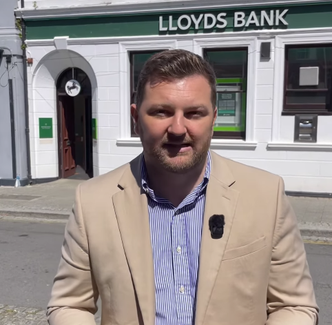 Samuel Kurtz MS outside Lloyds Bank closing branch Pembroke Dock