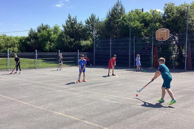 The pupils give hockey a go