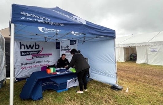 Carmarthenshire County Council celebrates the success of Hwb Bach y Wlad, which has reached over 11,000 individuals with vital support services.