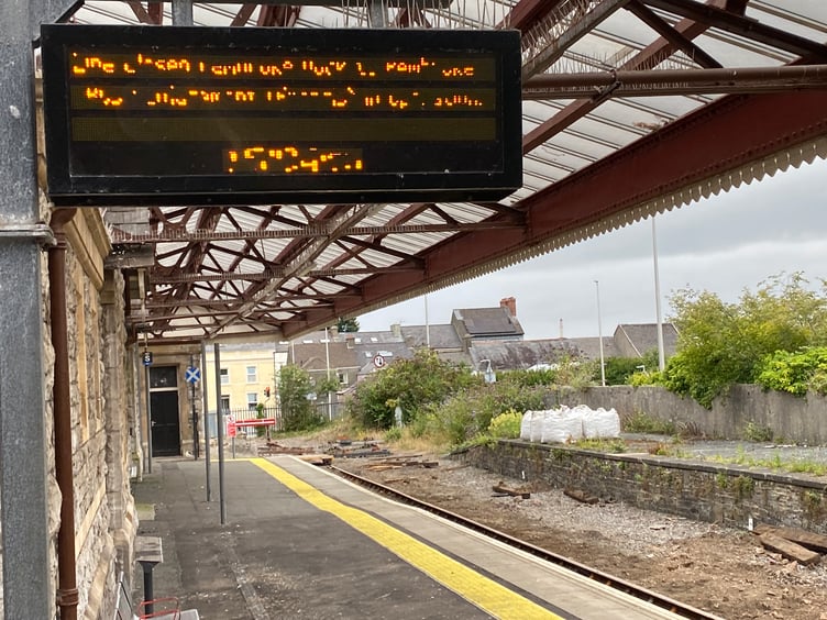 Illuminated sign at Pembroke Dock Railway Station (illegible)