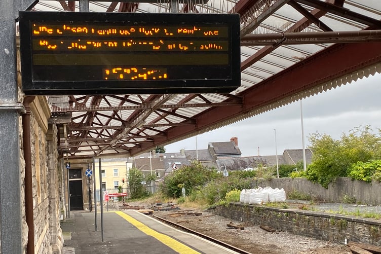 Illuminated sign at Pembroke Dock Railway Station (illegible)