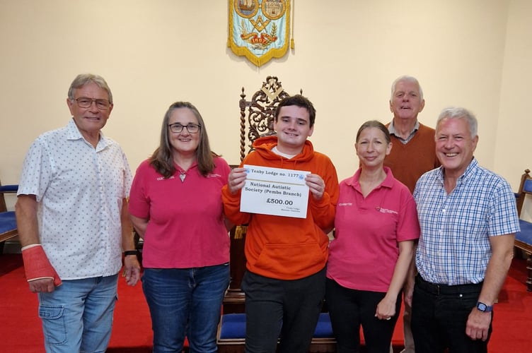 Pictured at Tenby Masonic Hall are Lodge Charity Steward Steve Thurgood, Gill with her son Zack and Helen from NAS Pembrokeshire, senior Lodge member Clive Webb and Lodge Master Tony Upham.