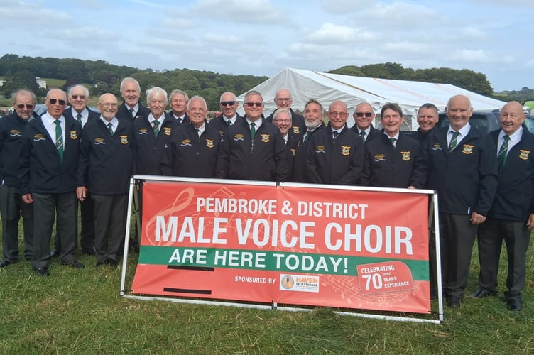 Wearing their new black zipper jackets, Pembroke and District Male Voice choristers sang to a large crowd at a very sunny Pembroke Farmers’ Club Annual Show at Lamphey recently.