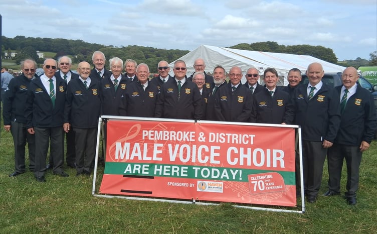 Wearing their new black zipper jackets, Pembroke and District Male Voice choristers sang to a large crowd at a very sunny Pembroke Farmers’ Club Annual Show at Lamphey recently.
