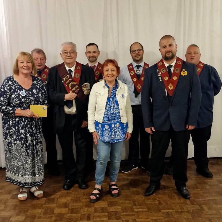 Milford Haven RAOB Harbour Lodge members present £400 to representatives from Forget-Me-Knot.